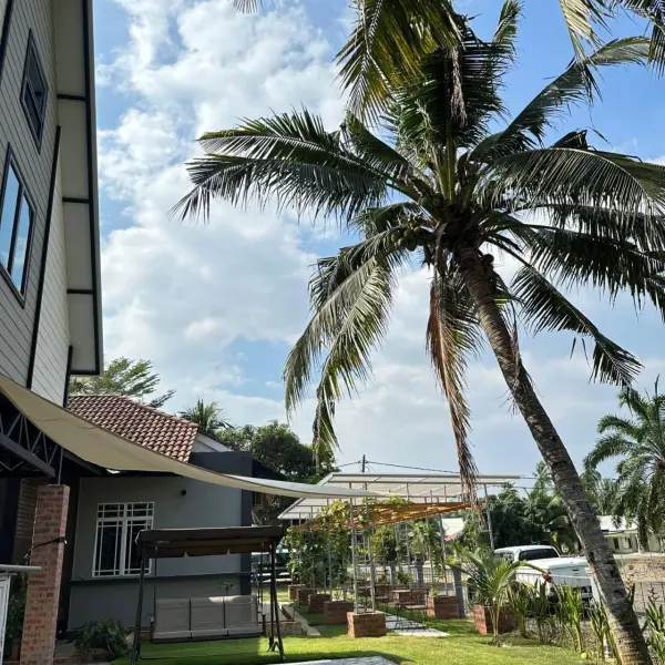 Tall coconut palm beside the cottages