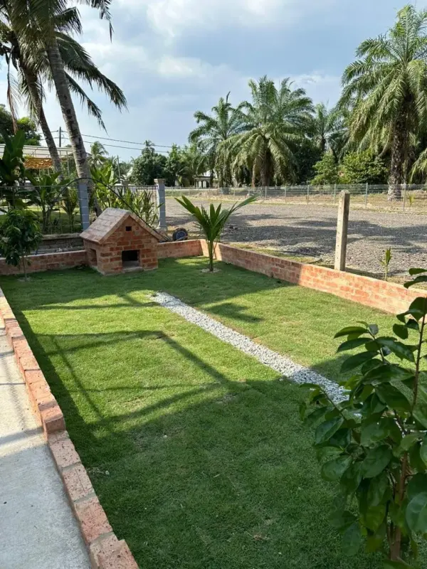 Green lawn with a small animal house