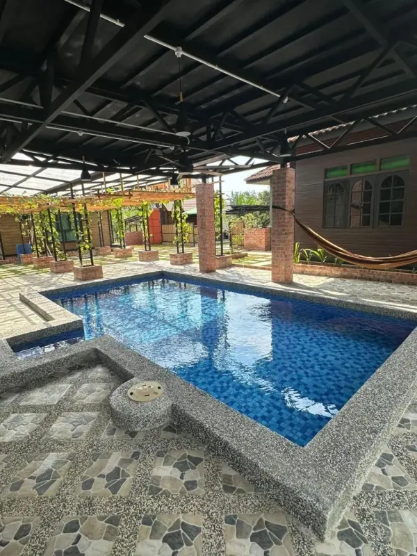 Blue-tiled swimming pool under a roof